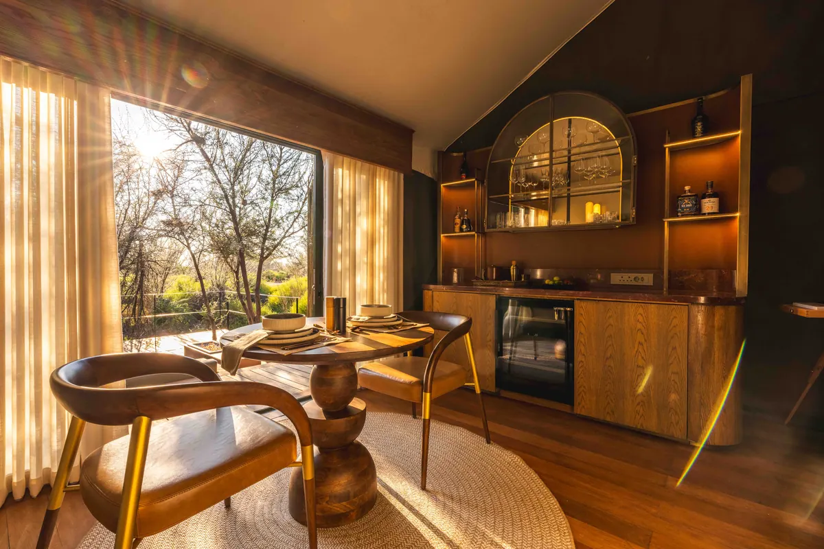 In-suite dining table and bar beneath an arched cabinet