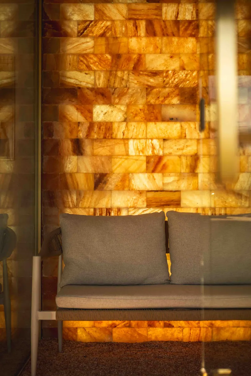 A glowing Himalayan salt wall and bench