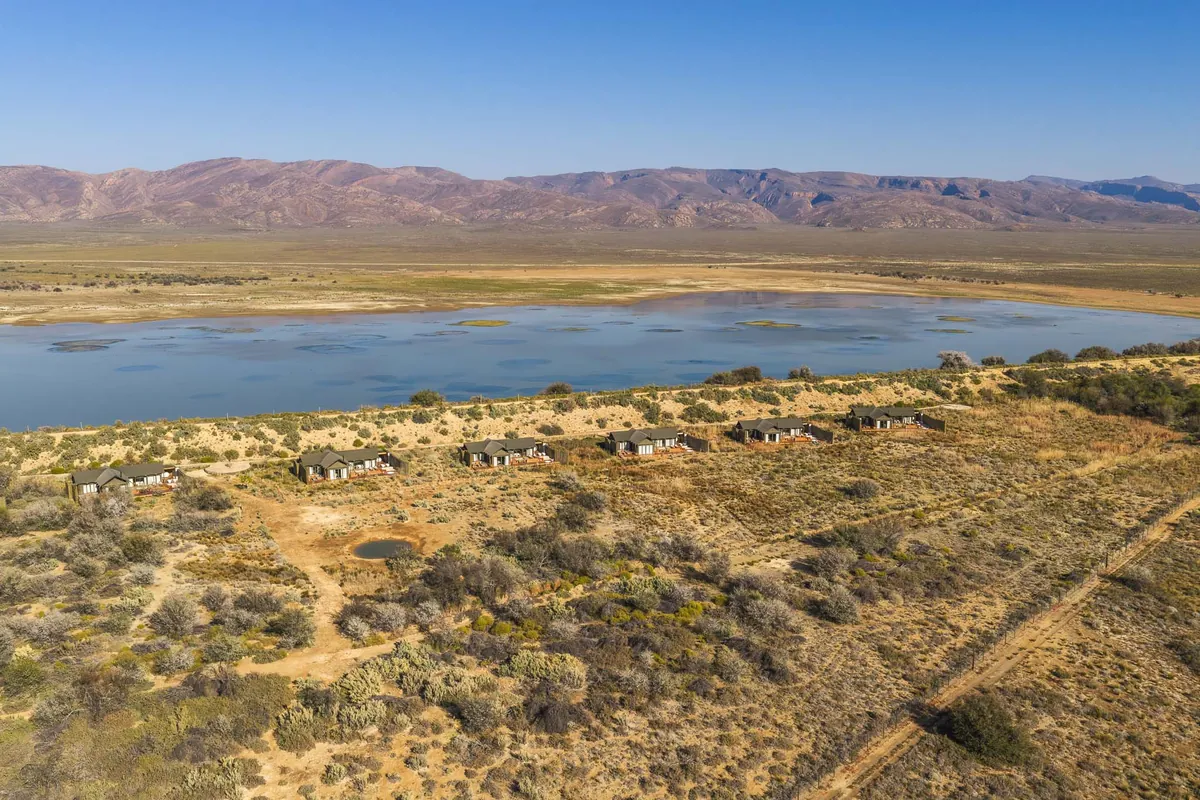 The conservancy and its watering hole beneath the Karoo ranges