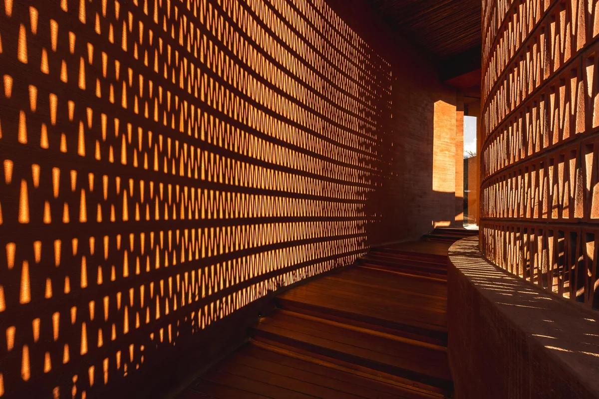 A perforated brick passage casting patterns of light
