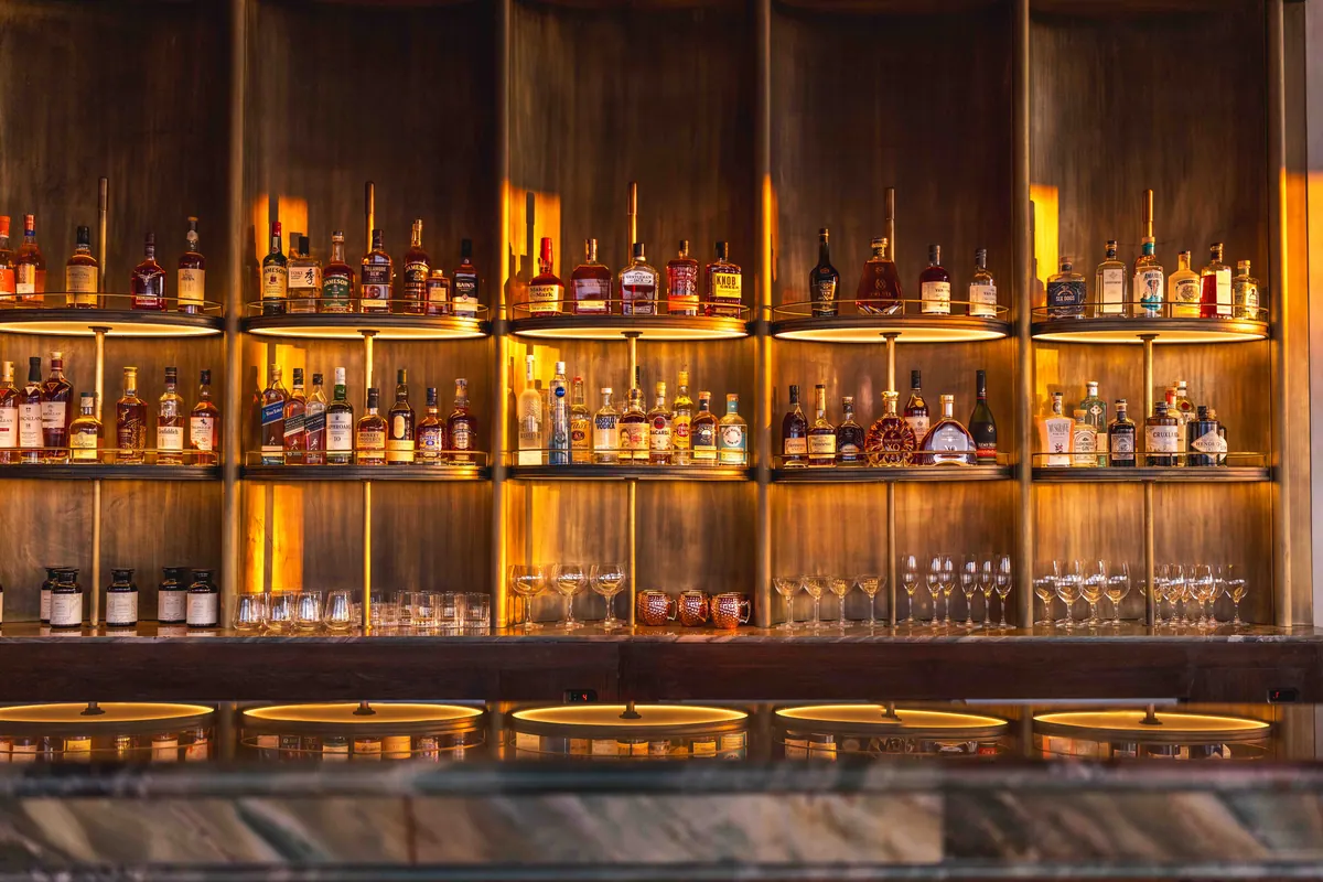 The bar counter and backlit shelves